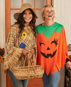 two women dressed up in costumes standing next to each other with pumpkins on them