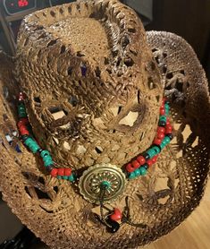 Red, Black, and Green beads. Concho has beaded fringe. The tie is long enough some may be able to wear it as a belt, about 48" The hat shown is not for sale. Red Adjustable Hat For Western-themed Events, Red Beaded Festival Hat, Western Red Hat Band, One Size Fits Most, Red Western Hat Band One Size Fits Most, Red Western Style Hat Band, One Size Fits Most, Red Western Hat Bands, One Size Fits Most, Red Western Hat Bands (one Size Fits Most), Red Adjustable Country Hat Bands, Adjustable Red Festival Hat