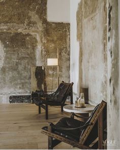 two chairs and a table in an old room