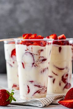 three dessert cups with strawberries in them