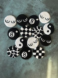 several black and white buttons with faces on them