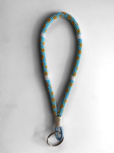 a blue and yellow lanyard with a metal hook