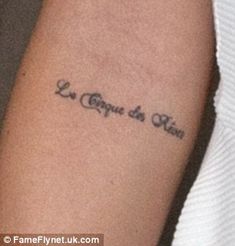 a woman with a tattoo on her arm that reads, le crayon du ten