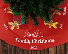 a family christmas tree skirt hanging on a wooden wall with the name santa's family christmas written across it