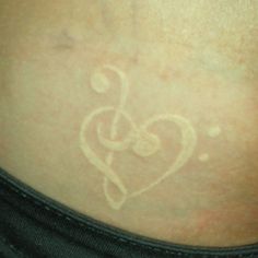 the back of a woman's stomach with a heart drawn on it