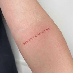 a woman's arm with the word memento vivree written on it