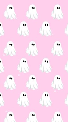 a pink background with white ghost faces on it