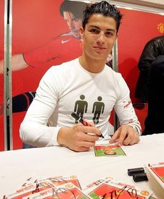 a man sitting at a table with cards in front of him