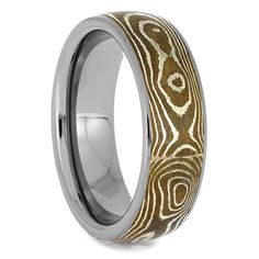 a wedding ring with gold and white wood inlay