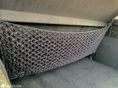 the interior of a vehicle with grey carpet and gray fabric on the back seat area