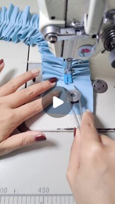 a woman is using a sewing machine to sew something