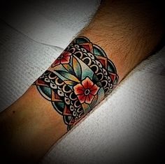 a person with a tattoo on their arm that has a flower in the middle of it