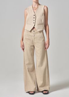 The Beverly Trouser is a polished take on the Beverly Slouch Boot, cut in an ultra-fluid denim with sophisticated trouser detailing. This fit is true to size. Looks Like: Classic khaki brownFeels Like: Rigid and breathable cotton blend with ultra-soft hand Closure: Zip FlyRise: 12 1/4"Inseam: 31 1/2"Leg Opening: 27"Model is 5'10" and is wearing a Size 27Fabric: 65% Lyocell 35% CottonCare Instructions: Machine wash cold inside out with like colors. Do not bleach. Tumble dry low. Taupe Pants, Tonal Dressing, Taupe Fabric, Cami Nyc, Cashmere Accessories, Sun With Sunglasses, Slouched Boots, Cashmere Turtleneck, Taos