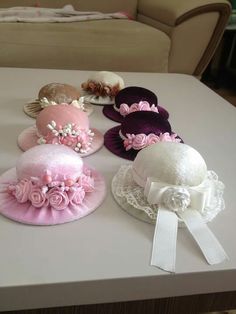 four hats are sitting on top of a table