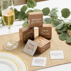 the table is set with wine glasses, napkins and place cards for guests to use