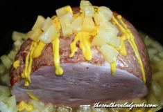 the ham is covered with yellow sauce and potatoes