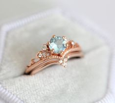 a close up of a ring on top of a white cloth with a diamond in the middle