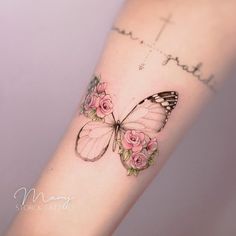 a butterfly with pink roses on it's arm