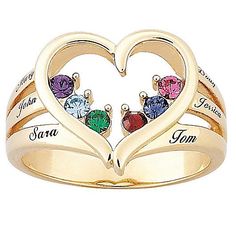 two heart shaped rings with names engraved on the sides and colored stones in each ring