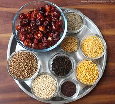 an assortment of beans and other foods on a metal tray