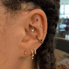 a close up of a person's ear with three different types of piercings