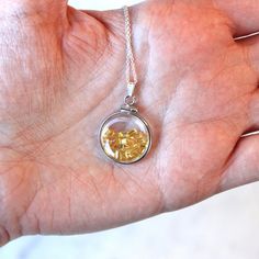 "Vibrant handcrafted brand new sterling silver genuine yellow sapphire shaker locket! This radiant pendant is dime sized with coin style bezels, and clear lucite covers. The round charm showcases genuine fancy sapphires in bright yellow hues. There is an estimated 2.5 CTW of faceted baguette cut sapphires sparkling within the double sided locket's clear lucite covers. A gorgeous piece of brand new gemstone jewelry, featuring beautiful genuine gems! ERA - New METAL / MATERIAL - Sterling silver lo Yellow Sapphire Round Gemstone Jewelry, Round Yellow Sapphire Gemstone Jewelry, Yellow Sapphire Gemstone Jewelry, Amber Faceted Round Jewelry, Faceted Citrine Jewelry As Gift, Spiritual Round Citrine Jewelry, Fine Jewelry: Silver Yellow Sapphire, Fine Jewelry Silver Yellow Sapphire Jewelry, Silver Yellow Sapphire Jewelry For Anniversary