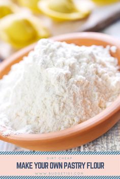 a bowl filled with flour sitting on top of a table