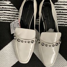 Studded White Loafer Spring Slip-on Flats With Metal Feet, Chic White Flats For Office, Flat Heel Loafers For Office In Spring, Formal Spring Flats With Metal Feet, Formal Flats With Metallic Accents For Spring, Chic White Loafers With Flat Heel, Trendy White Flat Loafers, Chic White Flat Heel Loafers, Casual Spring Flats With Metal Feet