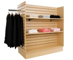 an open shelf with clothes hanging from it's sides and folded ones on the other side