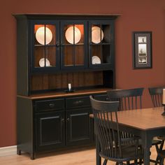 a dining room table and chairs in front of a hutch