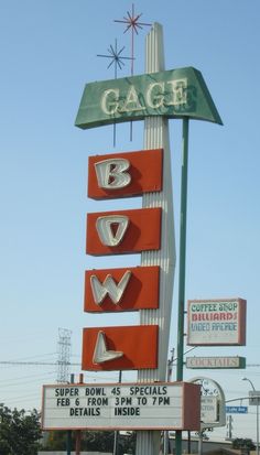 a sign for the gage bowling company in front of a building with other signs on it