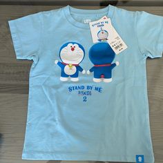 Cute Doraemon Unisex Tshirt Size 3-4 Cute Blue T-shirt With Cartoon Print, Playful Blue Shirt With Character Print, Playful Blue Shirt With Cartoon Print, Playful Light Blue Cartoon Print T-shirt, Playful Light Blue T-shirt With Cartoon Print, Cute Light Blue T-shirt With Cartoon Print, Fun Blue T-shirt For Playtime, Uniqlo Graphic Tee Short Sleeve, Uniqlo Graphic Tee With Short Sleeves