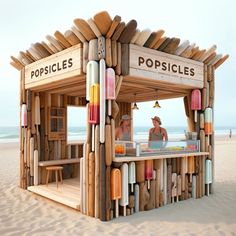 a small wooden booth with popsicles on the beach