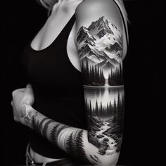 a woman with a tattoo on her arm and shoulder is standing in front of a mountain lake