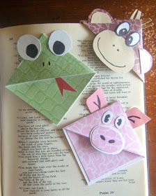 an open book with some paper animals on it