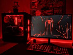 a desktop computer sitting on top of a desk in front of a red lit wall