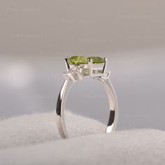 ◆ Featuring the dainty peridot in the shape of emerald, clear cubic zirconia like the angel wings appear on the sides of the green gemstone. A piece fits for elegance, suitable for engagement, party, daily occasion. ◆ Production Description: Main stone Type: Peridot Main Stone Shape: Emerald Main Stone Size: 6*8mm Side stone: CZ Metal: 925 Sterling silver - Other options available in the drop down menu ◆ Customization: √Free for Add Engraving √Other Metal Type Available √Other Gemstones & Sh Green Diamond Birthstone Ring With Accent Stones, Green Peridot Three Stone Jewelry, Green Three Stone Peridot Jewelry, Peridot Three Stone Jewelry As Gift, Three Stone Peridot Jewelry As Gift, Elegant Three Stone Peridot Ring, Green Peridot Diamond Ring With Accent Stones, Green Birthstone Ring With Diamond Accents For Wedding, Green Diamond Rings With Accent Stones