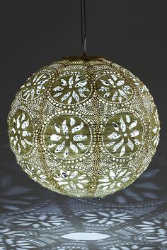 an intricately designed light fixture hanging from a ceiling