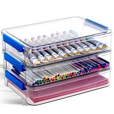 three tiered acrylic tray with markers and pencils in each compartment on white background