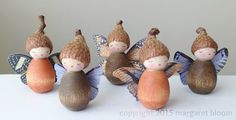 five little fairy figurines sitting on top of a table