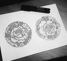 two drawings of flowers on paper next to a pen and ink drawing pencils are sitting on the table