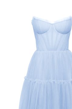 Dreamy tulle dress in light blue color with a light ruffled tulle maxi skirt. This dress has a heart-shaped boned semi-transparent bodice with built-in cups and a corset back, which makes the silhouette fitted and elegant. The A-line maxi skirt is made from multiple layers of delicate tulle that emphasize the hourglass silhouette. The waistline is adorned with a silver belt with Milla’s signature. Details: Material: Tulle Fabric composition: 100% Polyester, 100% Nylon Sleeve style: Sleeveless Silhouette: A-line Skirt length from waist: 116 cm / 45.6 inches Dress weight: 1.14 kg / 2.5 lbs Neckline: Heart-shaped neckline Back: Lacing closure Lining: Light blue full-length flared underskirt Model is: 180 cm / 83-60-95, wearing size S Art.N.: 9000-10 Light Blue Summer Midi Dress With Sheer Bodice And Tulle Material, Summer Maxi Dress With Tulle Skirt, Elegant Summer Tulle Corset Dress, Summer Tulle Dresses With Ruched Bodice, Summer Tulle Dress With Ruched Bodice, Summer Organza Dresses With Voluminous Skirt, Spring Dress With Sweetheart Neckline And Tulle Skirt, Summer Midi Dress With Sweetheart Neckline And Tulle Skirt, Sheer Tulle Evening Dress For Summer