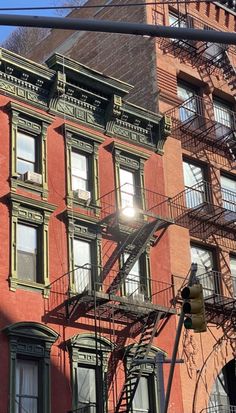 an apartment building with fire escapes on the second floor