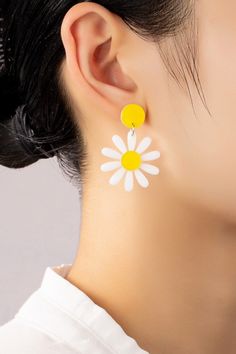 Daisy Drop Earrings: These lightweight acrylic daisy drop earrings make the perfect 90s throwback accessory! Made of white and yellow acrylic with push pack posts to keep them secure.Length: 1 inches x 1.5 inches Trendy White Plastic Earrings, Trendy White Earrings, Trendy White Daisy Shaped Jewelry, White Plastic Summer Jewelry, White Plastic Jewelry For Summer, Trendy White Daisy-shaped Jewelry, Trendy Yellow Plastic Earrings, Retro White Drop Earrings, Trendy Yellow Flower Earrings