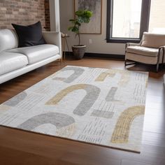 a living room with white couches and a large rug