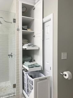 an open door to a bathroom with towels and toiletries in the closet next to it