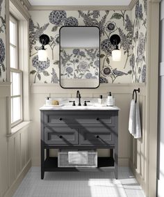 a bathroom with two sinks and a large mirror above the sink is decorated in floral wallpaper