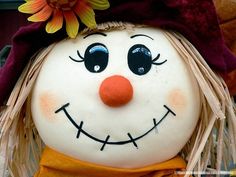 a close up of a scarecrow head with a flower on it's forehead