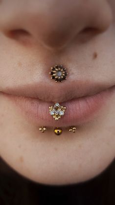 a close up of a person's nose with two piercings attached to it