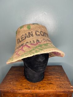 *Handmade individual bucket/sun hat crafted from a coffee bean sack with a lining of pre-loved twill cotton. *Size: Medium - Circumference 24" *This unique hat shows printed/stencilled words Café de Nica and clean coffee on the main body of the hat. The outer brim has general stencilled coloured letters & images relating to the coffee manufacturer, the top and inner brim are plain. *Care instructions: machine washable 30 degrees - cool wash - line dry. Iron using a steam setting. The hat is indi Coffee Bean Sacks, Clean Coffee, Unique Hats, Coffee Bean, Bucket Hats, Safety Pin, Hat Crafts, Coffee Beans, Sun Hats